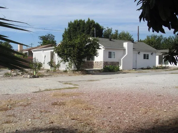 a view of the house with a yard
