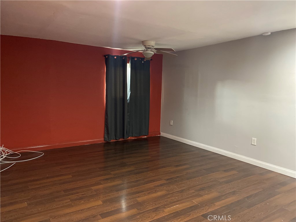 10756 Haddon Avenue Pacoima, CA 91331 - Photo 11 of 22 a view of an empty room with wooden floor