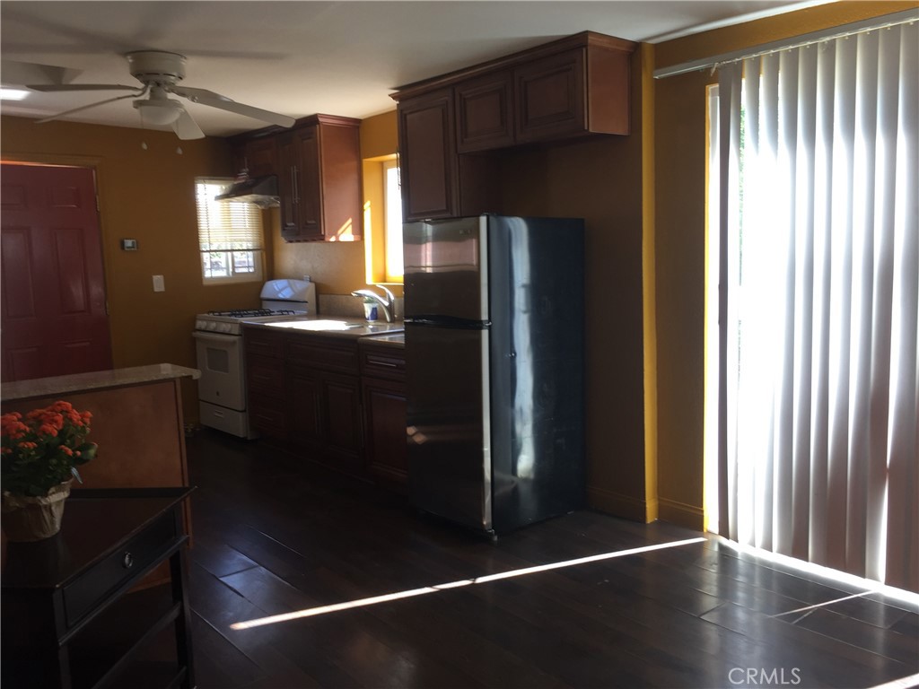 10756 Haddon Avenue Pacoima, CA 91331 - Photo 21 of 22 a kitchen with stainless steel appliances granite countertop a refrigerator and a sink