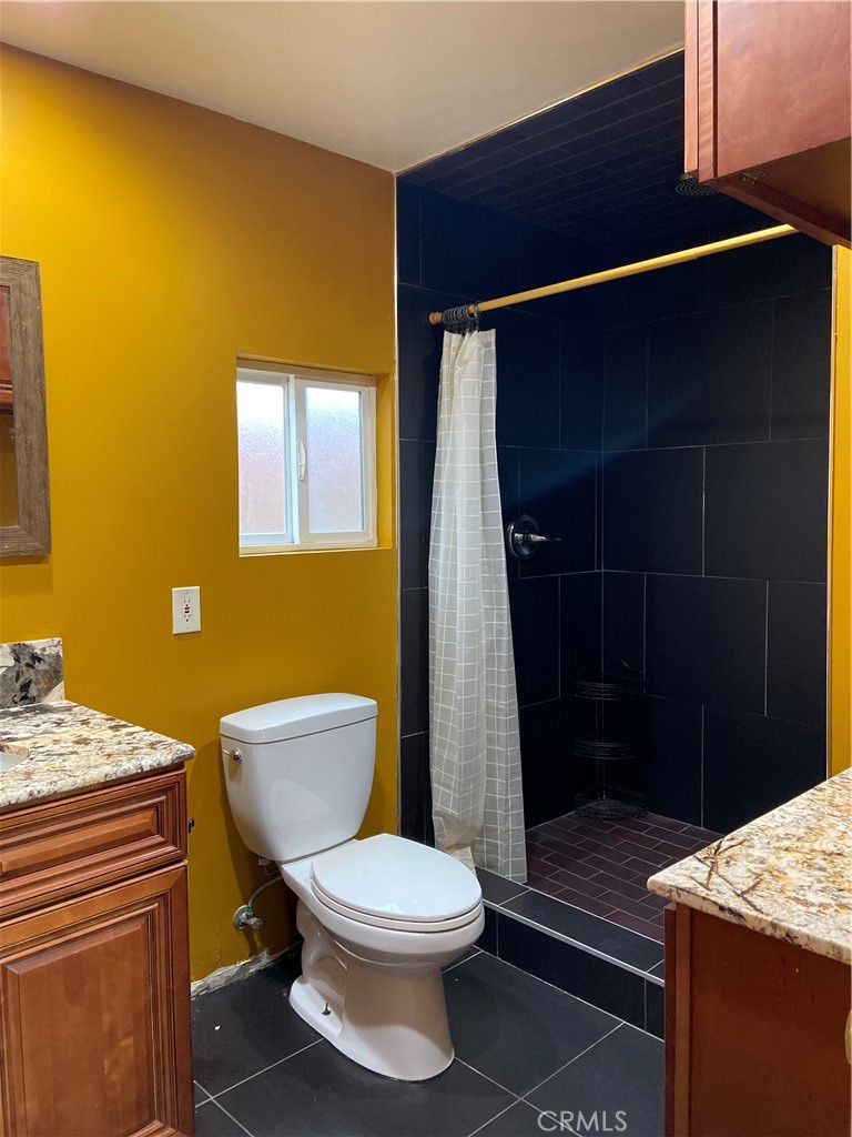 10756 Haddon Avenue Pacoima, CA 91331 - Photo 10 of 22 a bathroom with a toilet and a shower
