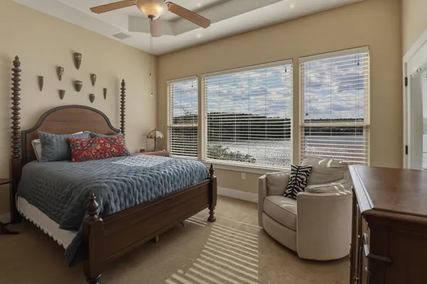 a spacious bedroom with a bed and a large window