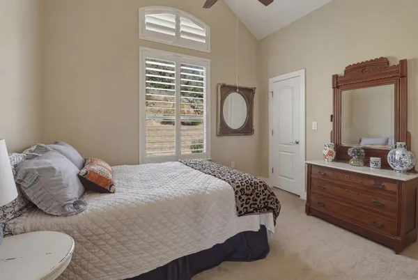 a bedroom with a bed and window