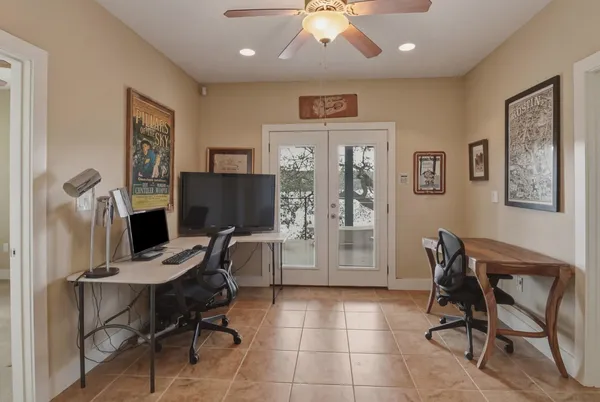 a view of a workspace with furniture and a window