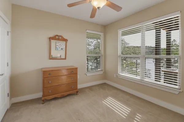 a view of room with window and a ceiling fan