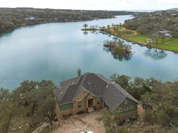 an aerial view of a house with a lake view