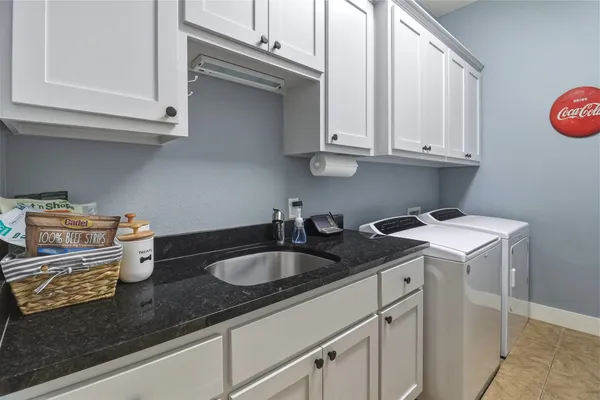 a kitchen with sink cabinets and stove