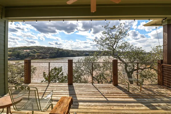 a view of a balcony with wooden floor and city view