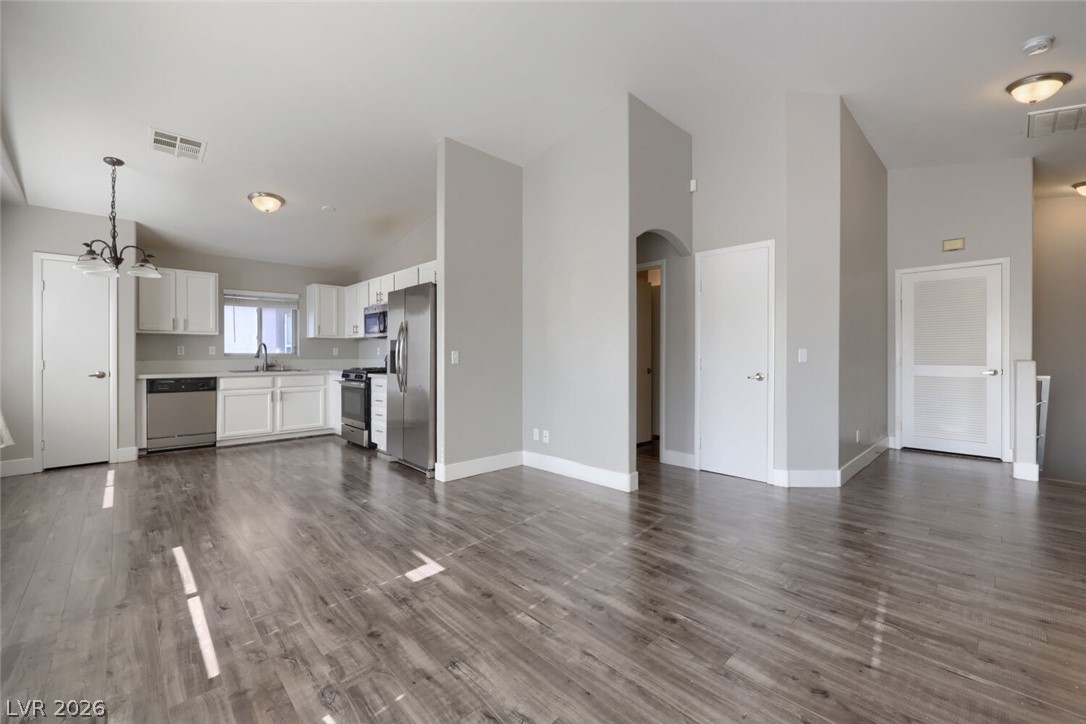 5985 High Steed Street, Unit 101 Henderson, NV 89011 - Photo 38 of 38 An open floorplan seamlessly connects the kitchen and living areas, offering effortless movement throughout.