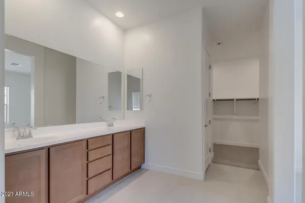 a bathroom with a double vanity sink and mirror
