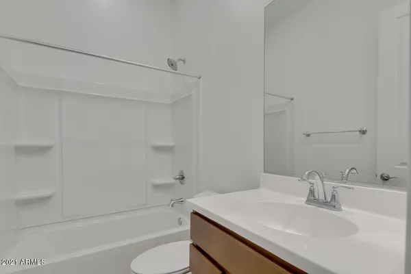 a bathroom with a sink toilet vanity and shower