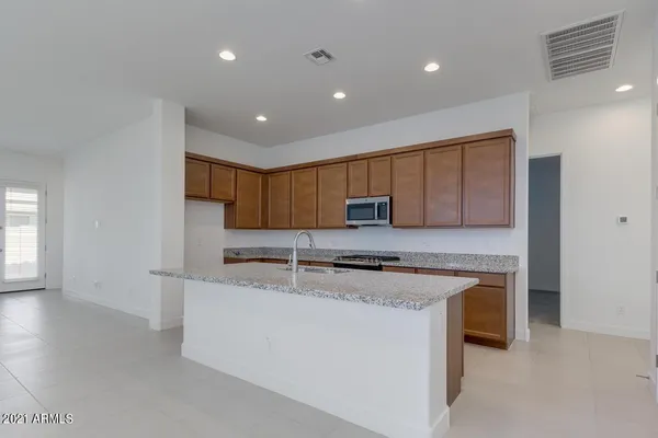 a large kitchen with stainless steel appliances granite countertop a sink and a stove