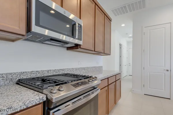 a stove top oven sitting inside of a kitchen