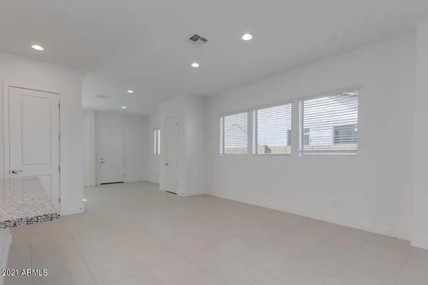 an empty room with windows and closet