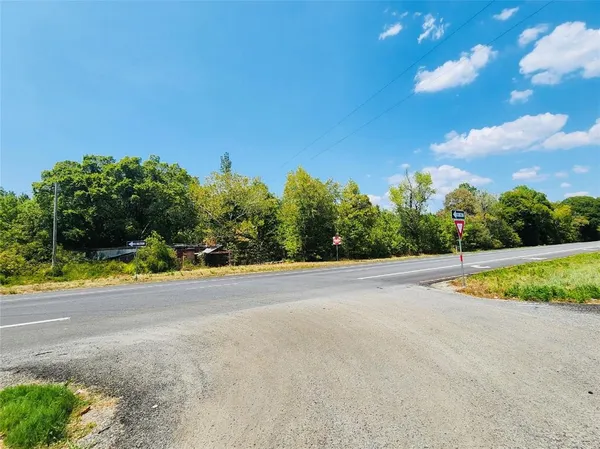 a view of a swimming pool and trees in the background