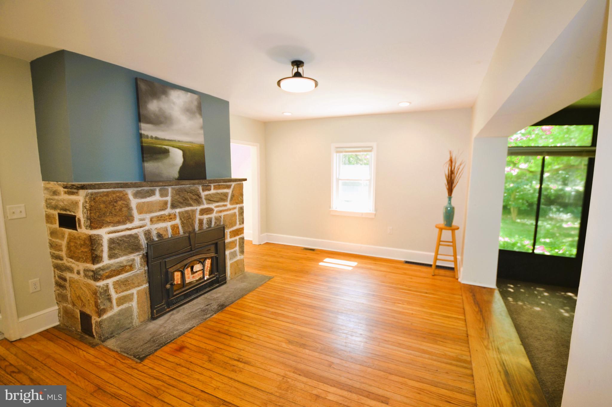 920 Branch Road Newark, DE 19711 - Photo 10 of 22 Dining Room with Fireplace and Sunroom Access