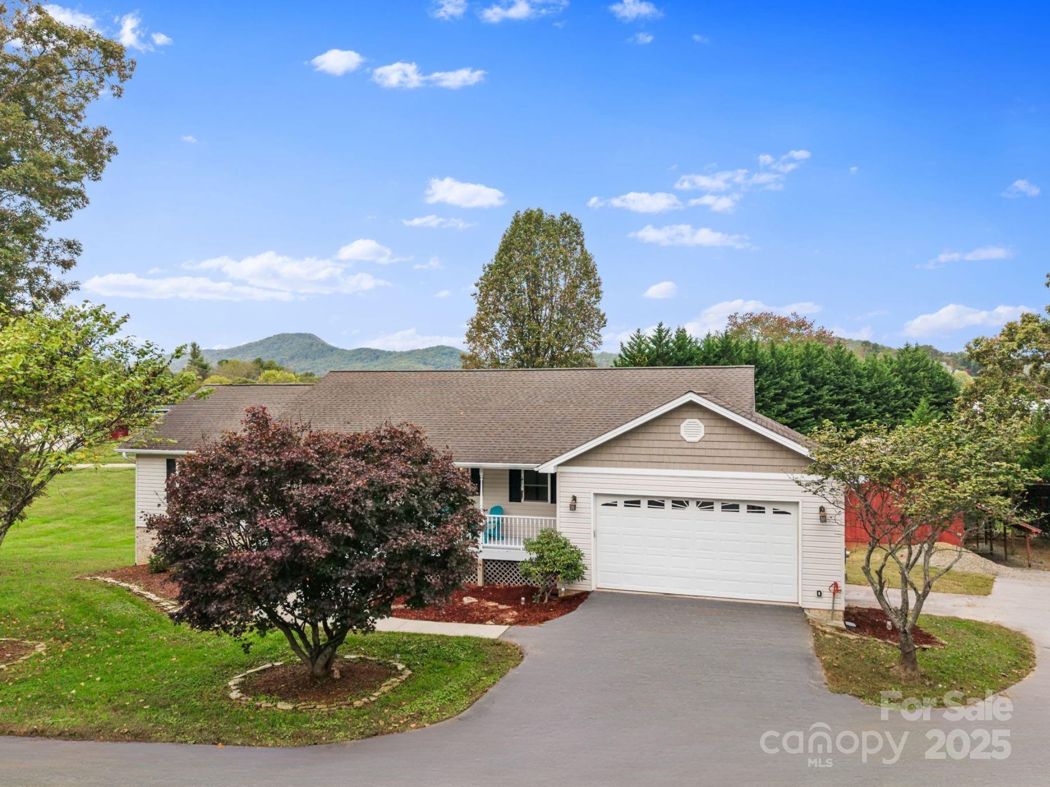 a view of a house with a yard and garage