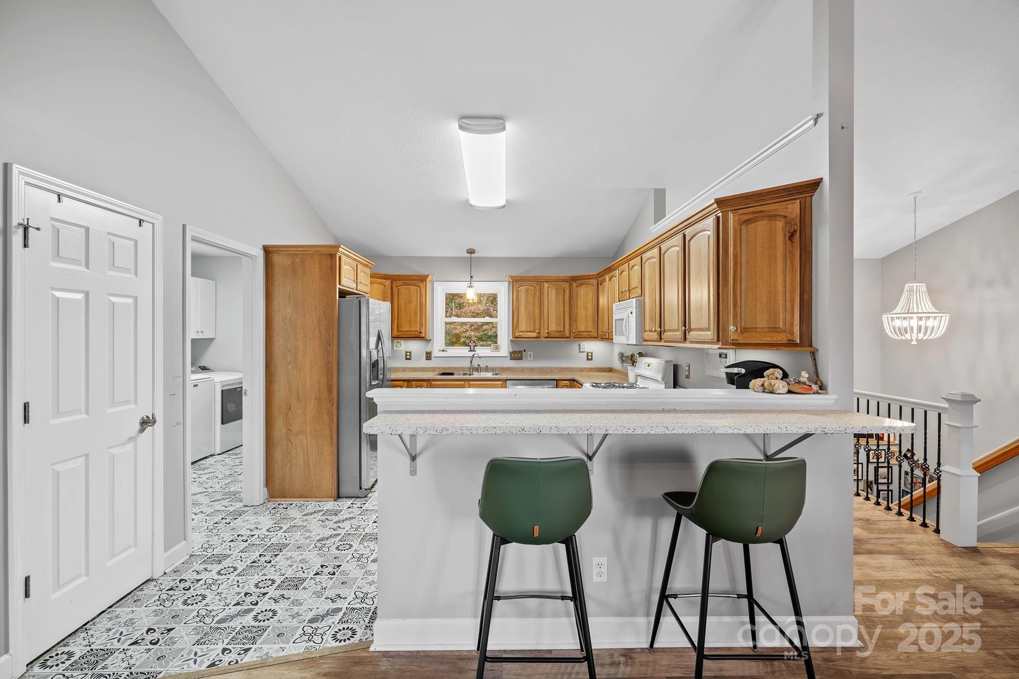21 Presbyterian Church Road Mills River, NC 28759 - Photo 11 of 48 a kitchen with stainless steel appliances a table and chairs in it