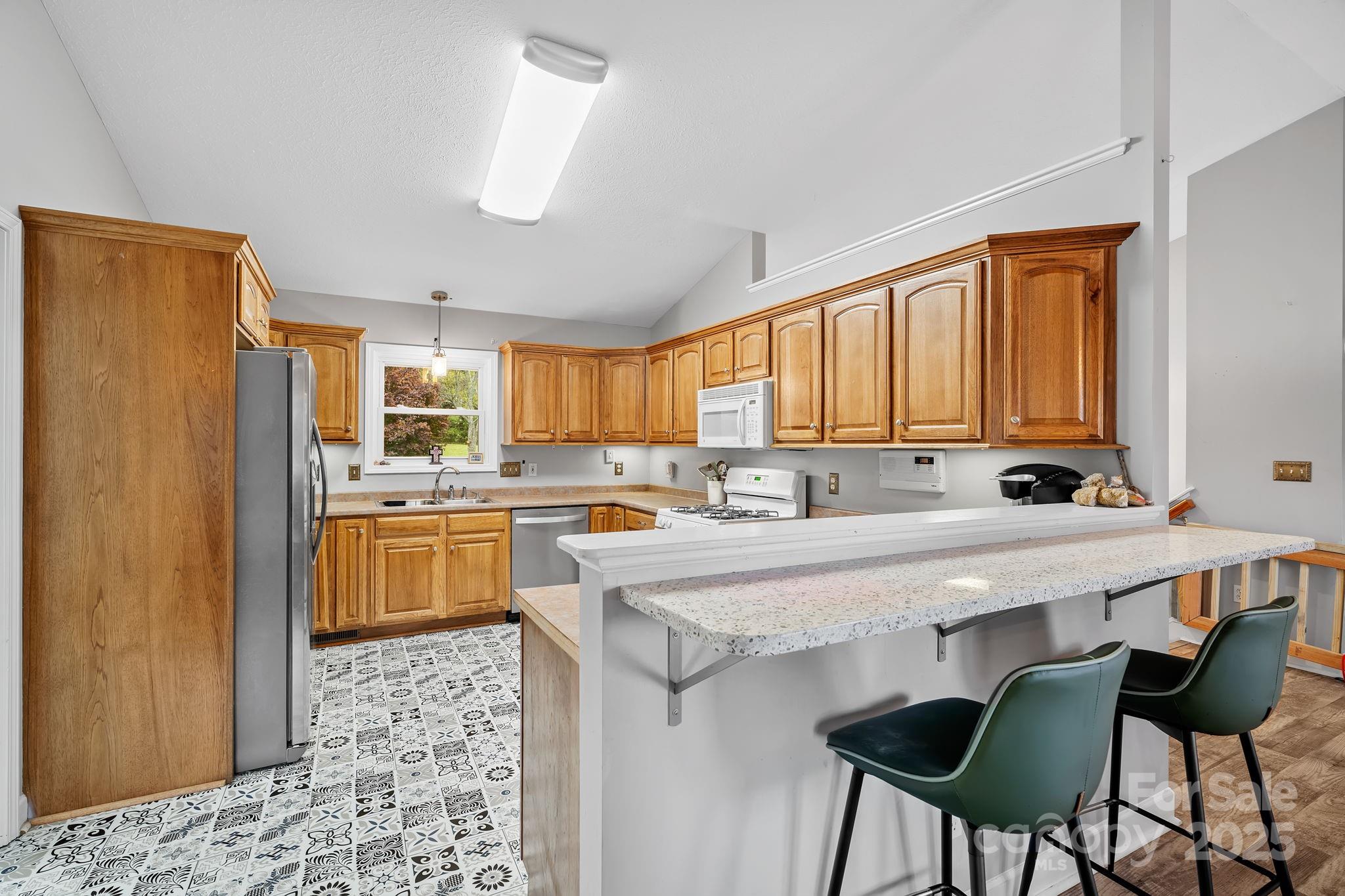 21 Presbyterian Church Road Mills River, NC 28759 - Photo 12 of 48 a kitchen with stainless steel appliances granite countertop a sink counter space and windows