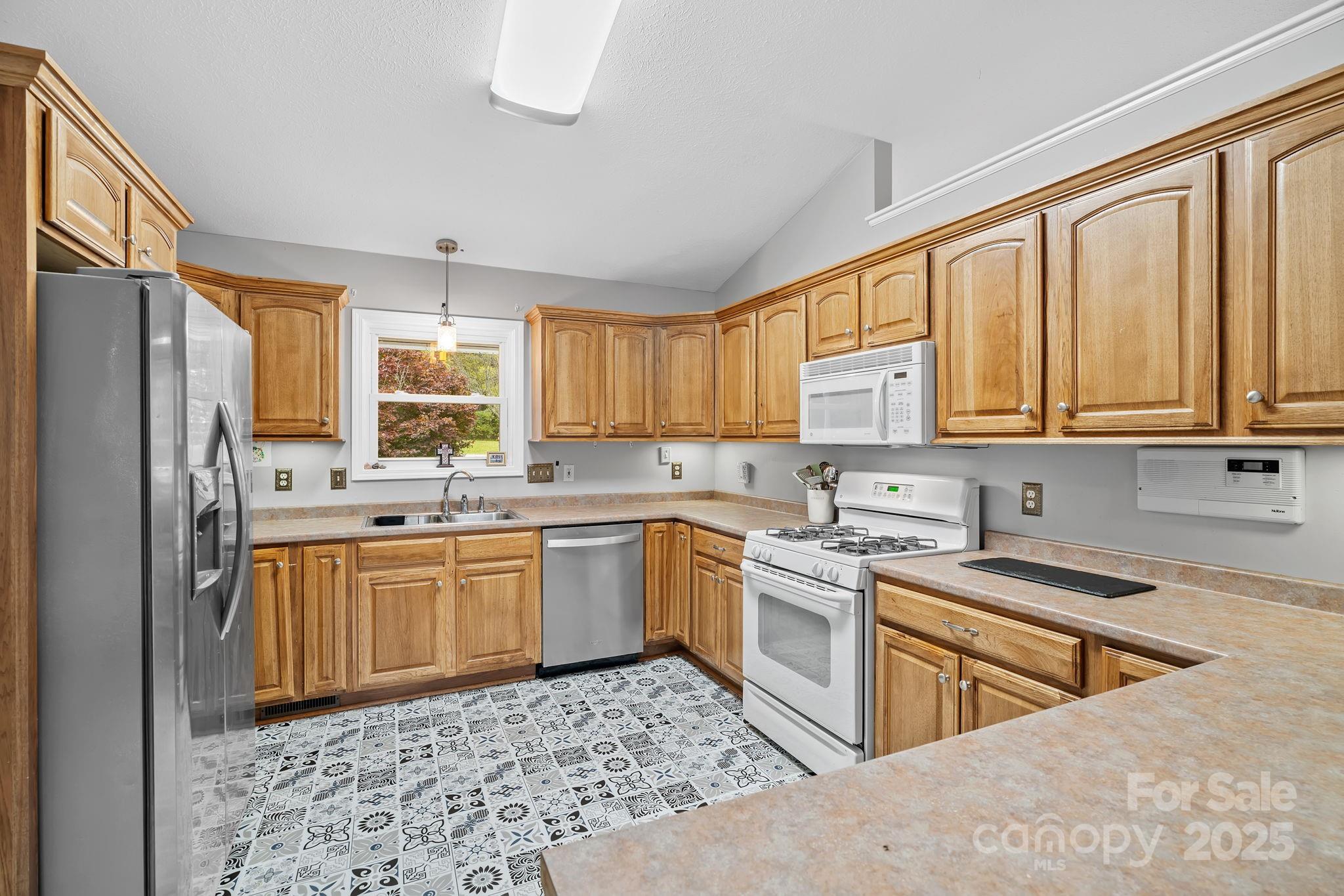 21 Presbyterian Church Road Mills River, NC 28759 - Photo 13 of 48 a kitchen with stainless steel appliances granite countertop a stove a sink dishwasher a refrigerator and cabinets with wooden floor