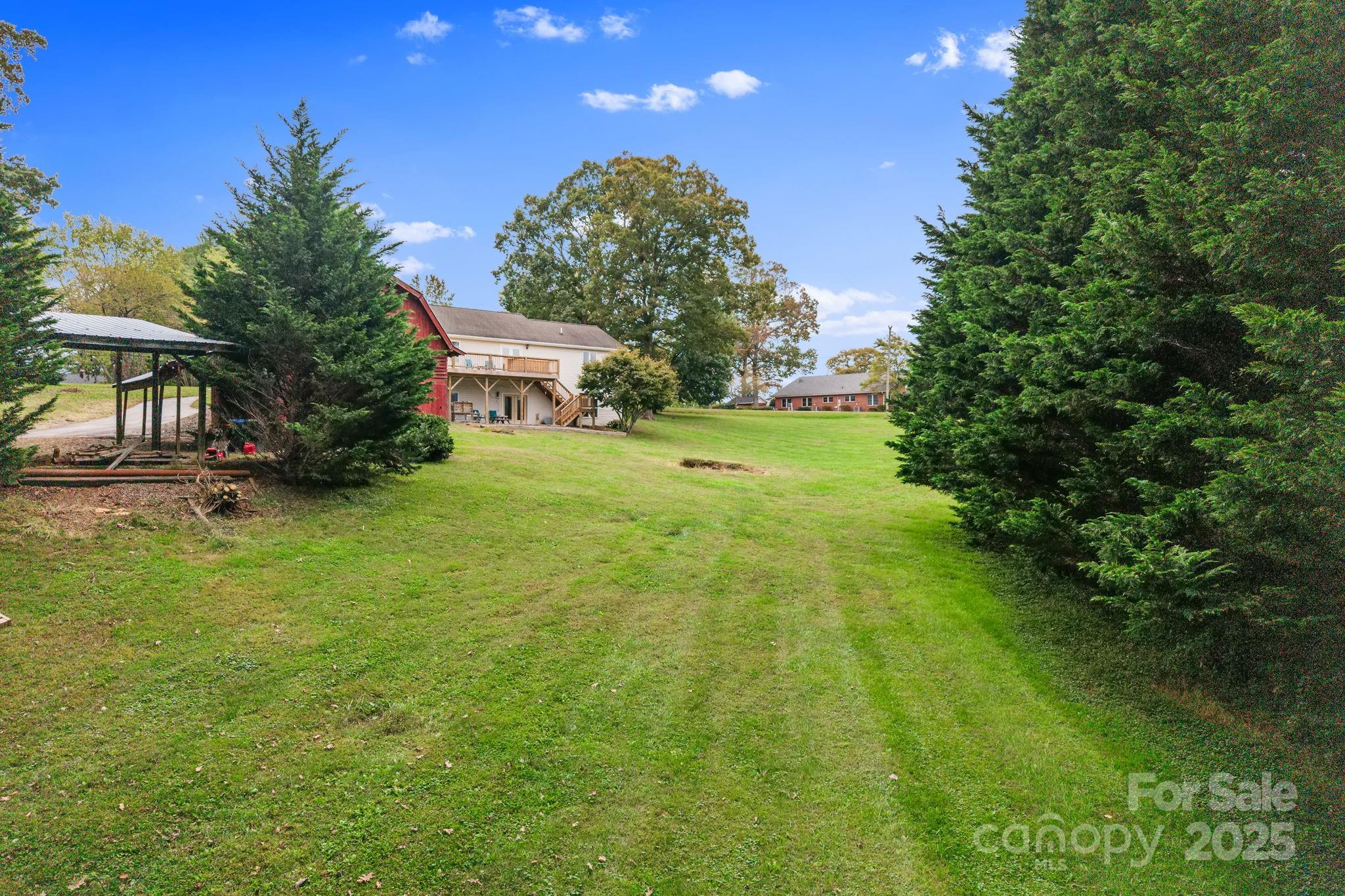 21 Presbyterian Church Road Mills River, NC 28759 - Photo 4 of 48 a backyard of a house with plants and large trees