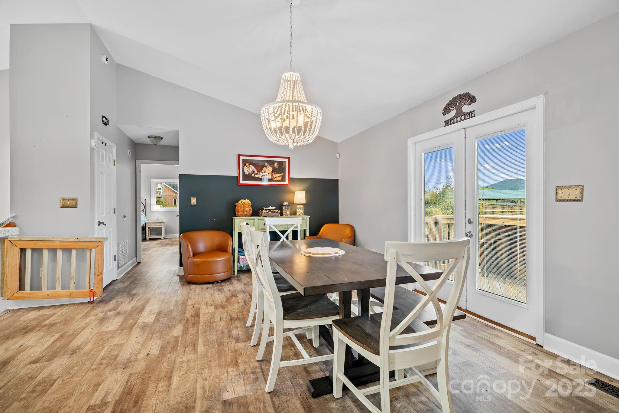 21 Presbyterian Church Road Mills River, NC 28759 - Photo 9 of 48 a view of a dining room with furniture a chandelier and wooden floor