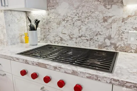 a bedroom with a bed and large windows