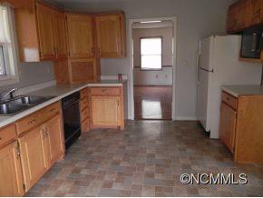 145 Hightower Road Forest City, NC 28043 - Photo 3 of 14 a kitchen with granite countertop a refrigerator and a stove