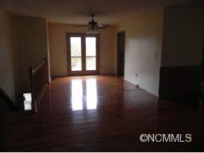 145 Hightower Road Forest City, NC 28043 - Photo 5 of 14 a view of an empty room with wooden floor and a window