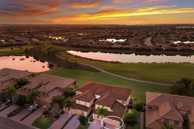 an aerial view of a house with yard swimming pool and ocean