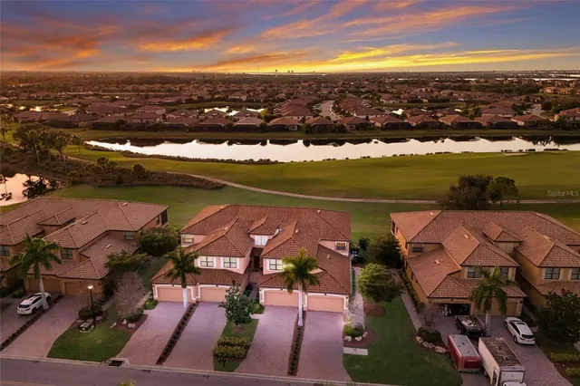 an aerial view of residential houses with outdoor space