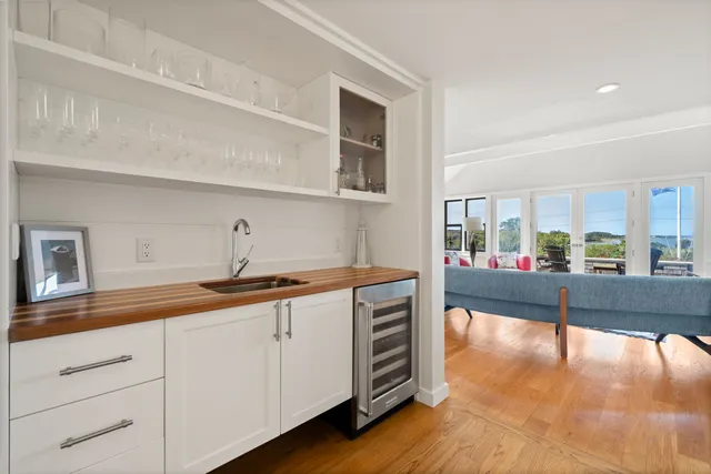 a spacious bedroom with a bed a couch and a window with wooden floor