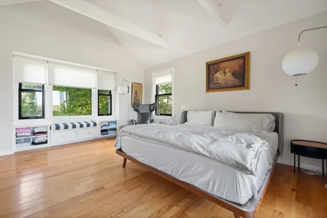 a bathroom with double vanity sinks a large mirror and a window