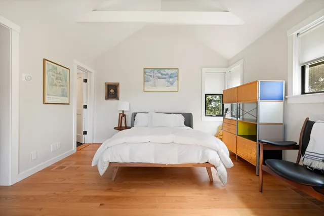 a view of a room that has a bed and a window