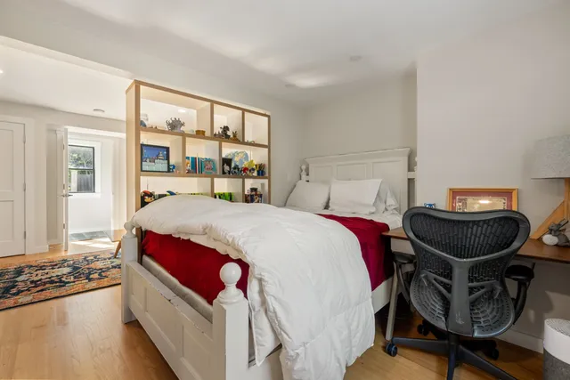 a bedroom with a bed and a large window with outer view