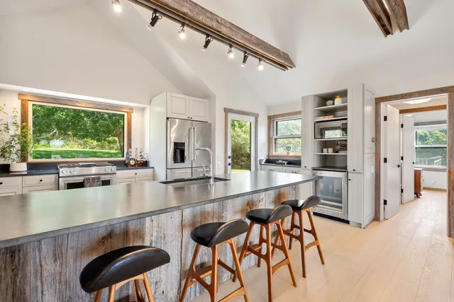a kitchen with stainless steel appliances granite countertop sink stove and refrigerator