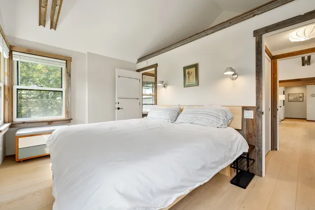 a bathroom with a toilet a sink a mirror a vanity and shower