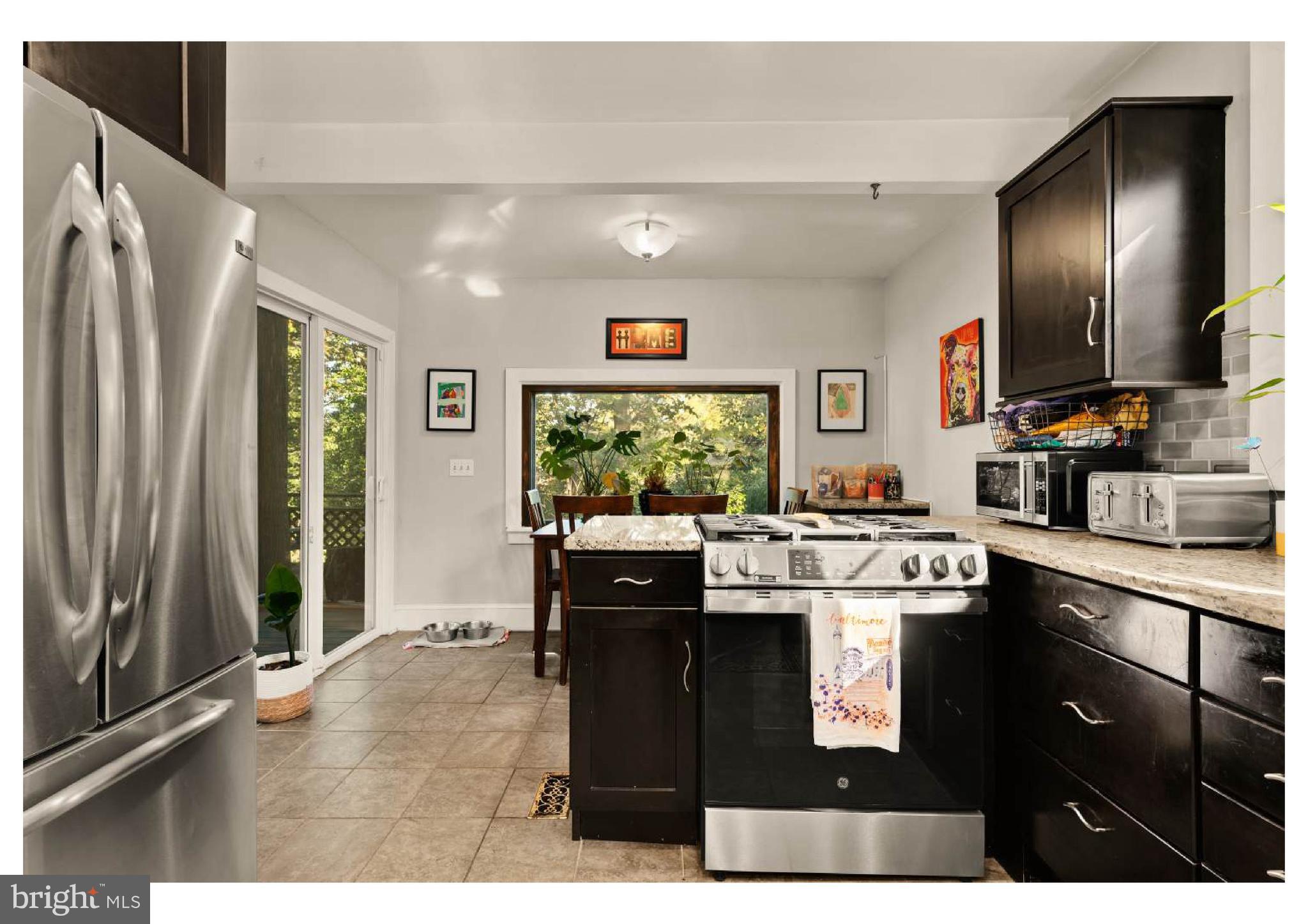 610 St Dunstans Road Baltimore, MD 21212 - Photo 15 of 44 a kitchen with stainless steel appliances kitchen island granite countertop a sink stove and refrigerator