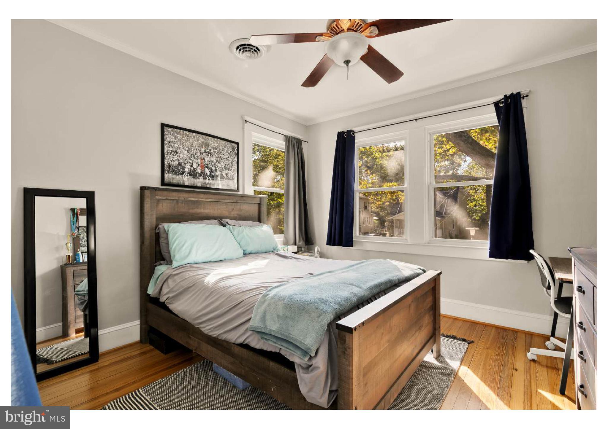 610 St Dunstans Road Baltimore, MD 21212 - Photo 25 of 44 a bedroom with a bed a bookshelf and a large window