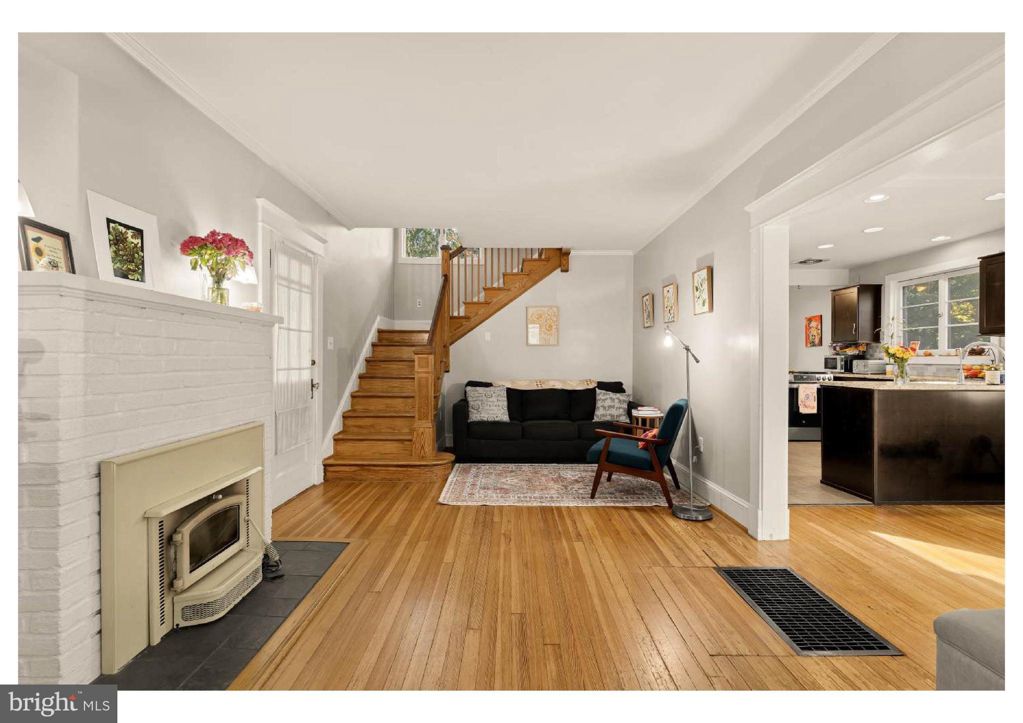 610 St Dunstans Road Baltimore, MD 21212 - Photo 7 of 44 a living room with a fireplace and wooden floor