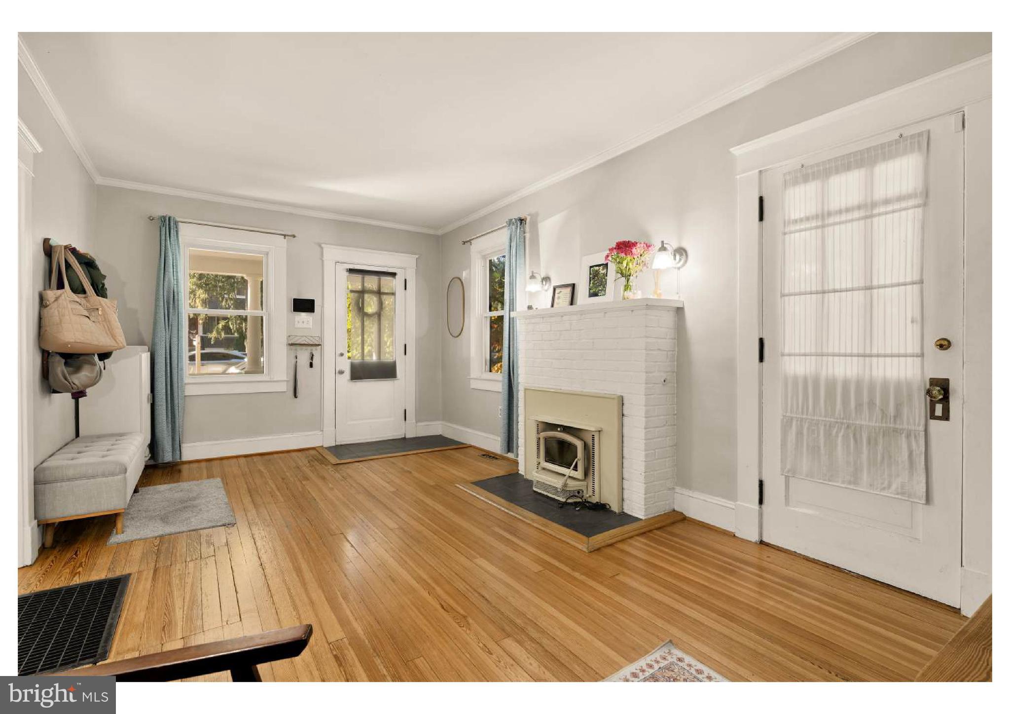 610 St Dunstans Road Baltimore, MD 21212 - Photo 8 of 44 a view of empty room with wooden floor and fireplace