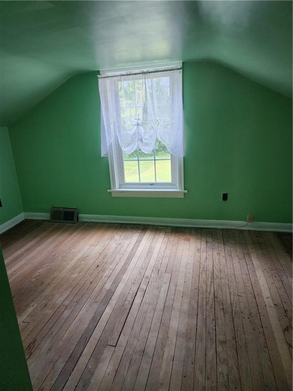 844 Rose Stop Road New Castle, PA 16101 - Photo 13 of 28 an empty room with wooden floor and windows