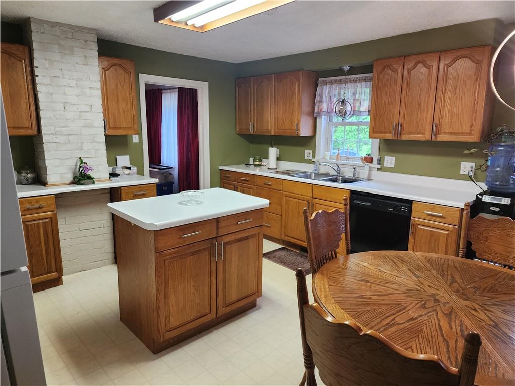 844 Rose Stop Road New Castle, PA 16101 - Photo 3 of 28 a kitchen with stainless steel appliances granite countertop a sink a stove and a refrigerator