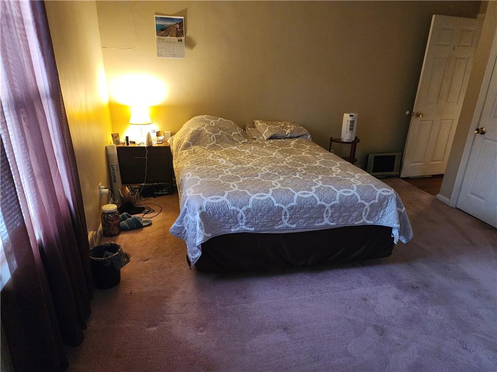 844 Rose Stop Road New Castle, PA 16101 - Photo 9 of 28 a bedroom with a bed and wooden floor
