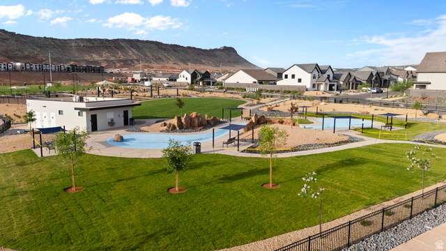 2133 Wolverine Way, Unit 2440 Washington, UT 84780 - Photo 34 of 39 Expansive green space featuring a modern splash pad, a dedicated facility building, and multiple shaded seating areas