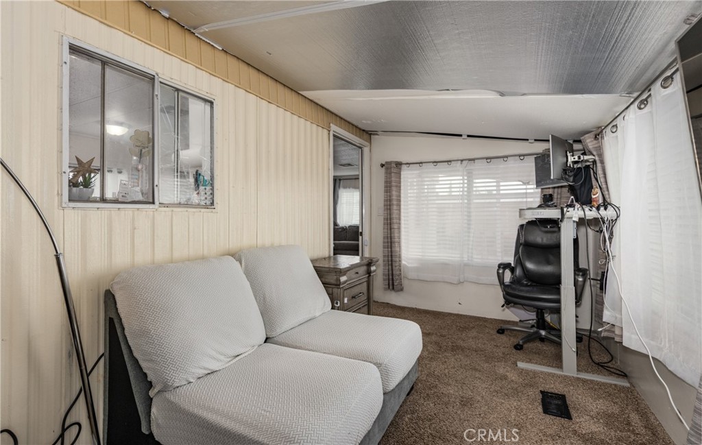 26838 9th Street, Unit F2 Highland, CA 92346 - Photo 14 of 18 a living room with furniture and a flat screen tv