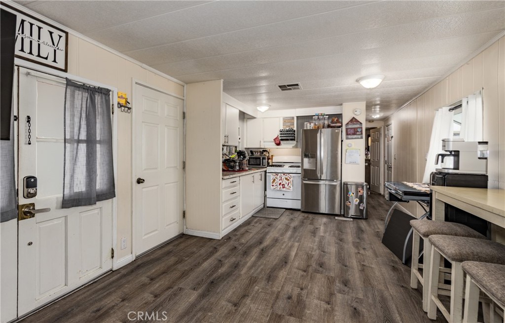 26838 9th Street, Unit F2 Highland, CA 92346 - Photo 2 of 18 a kitchen with stainless steel appliances a refrigerator and a stove top oven