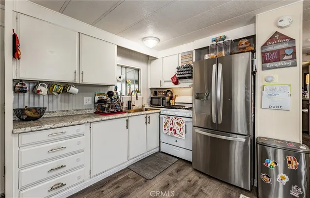 a kitchen with stainless steel appliances a refrigerator sink and cabinets