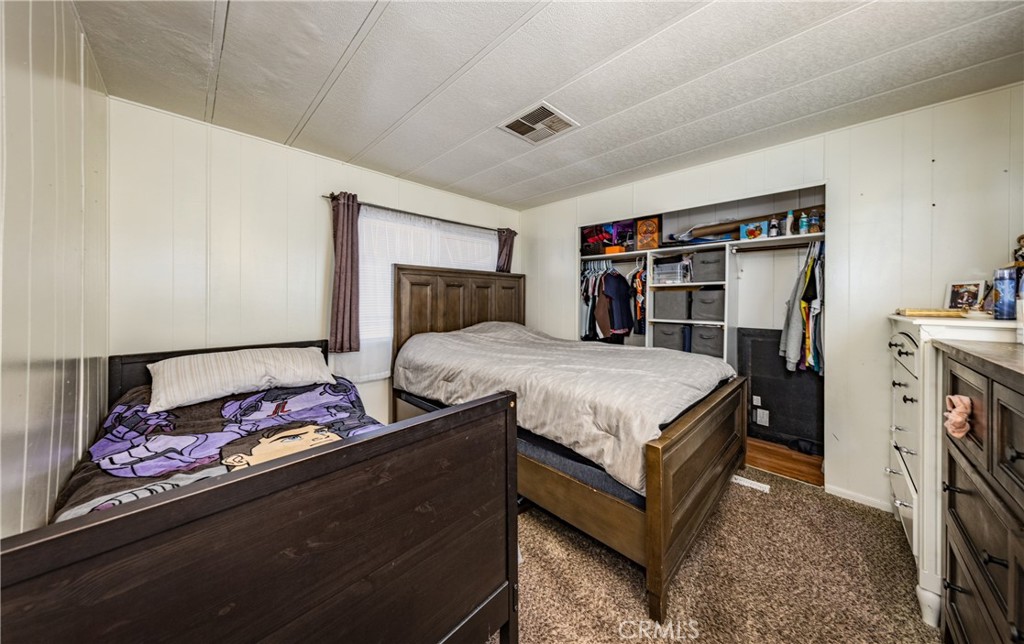 26838 9th Street, Unit F2 Highland, CA 92346 - Photo 9 of 18 a bedroom with a bed and a dresser