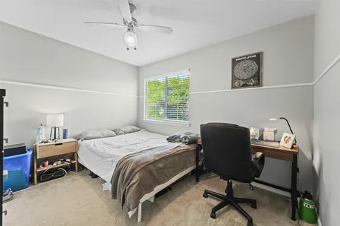 a bedroom that has a bed and a chair in it