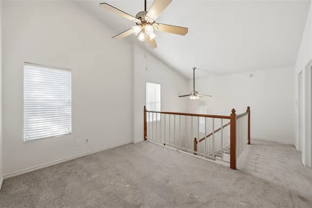 a view of empty room with ceiling fan